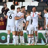 MK Dons celebrate Warren O’Hora’s excellent second goal against Swindon Town