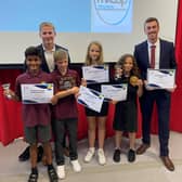 Jake Saville, right, PE Teacher Dan Hobley and Two Mile Ash School pupils celebrate winning the award for PE lesson and sports in MK